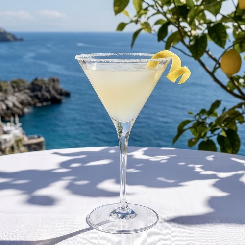 Lemon Drop cocktail in a sugar-rimmed martini glass with a lemon twist.